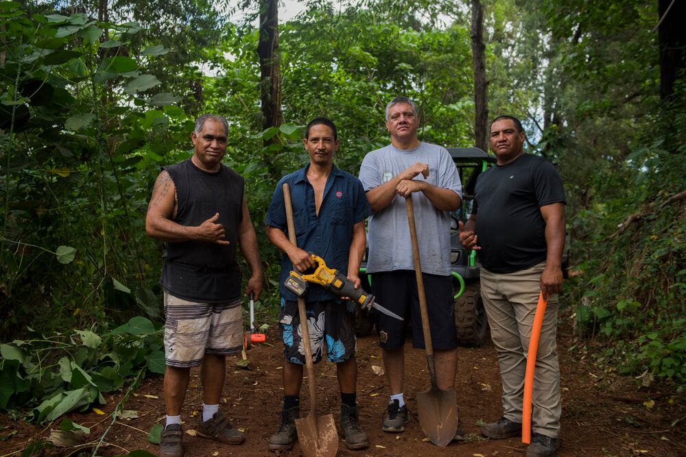 Four men with tools building a community network in Hawaii