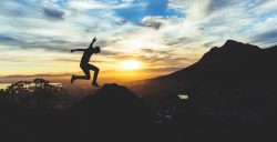 Person jumping at sunset