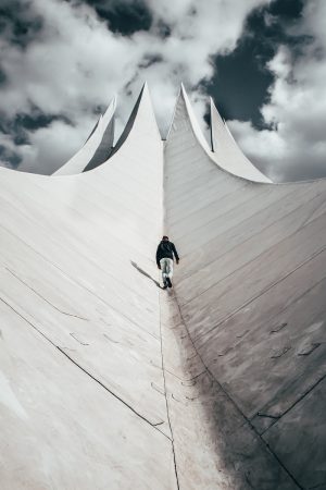 A man walking up the concrete monument. 