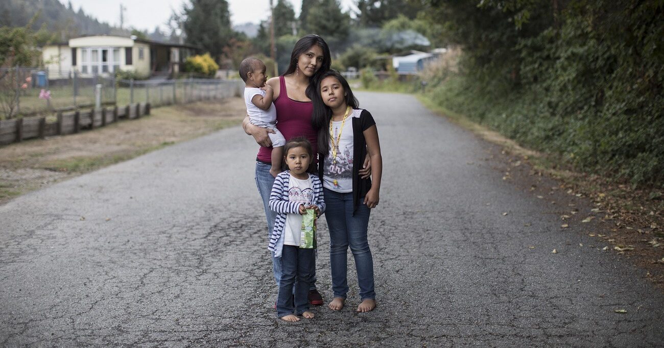 Native American Mother and Three Children Take a Walk Around the Neighborhood.