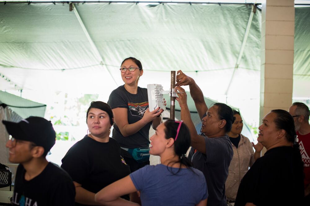 A woman holding a wireless antenna in Hawaii