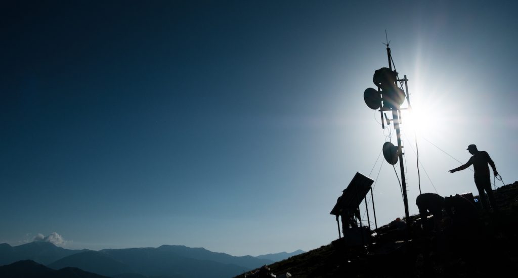 People putting up a tower for Internet access