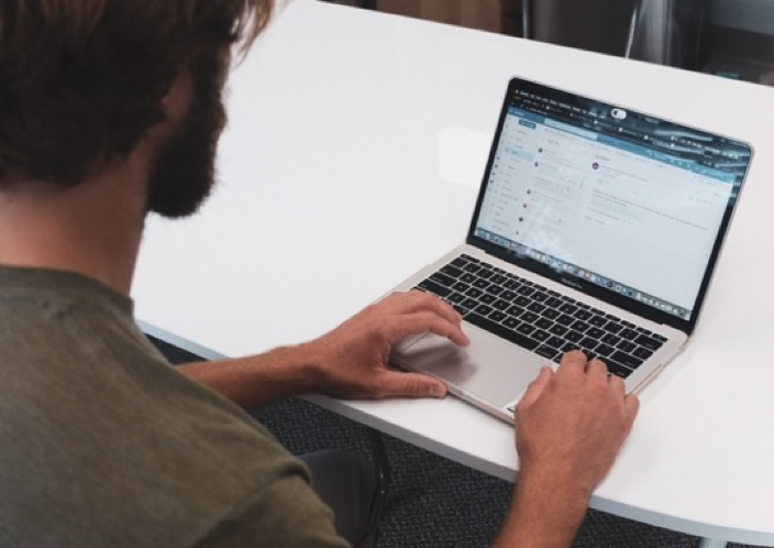 A man in front of a laptop