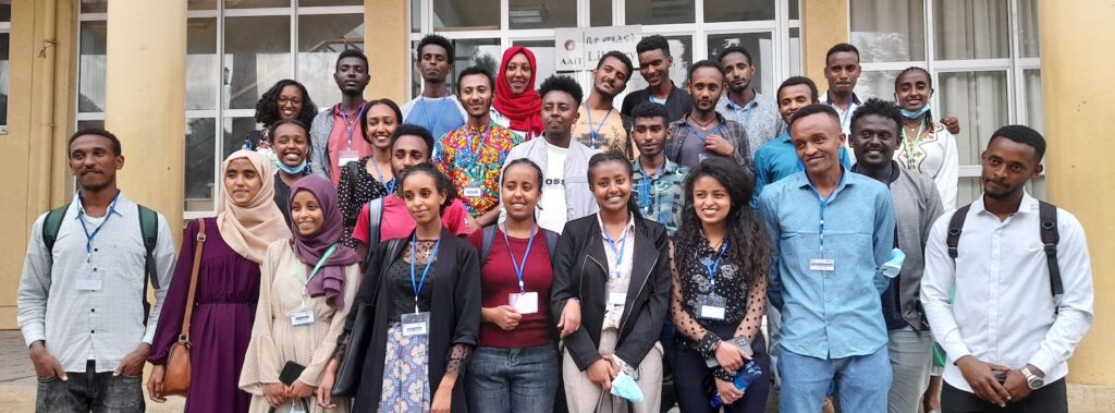 A group of people standing and smiling