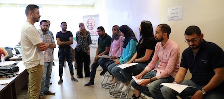 A group of people brainstorming at an event, some sitting, some standing