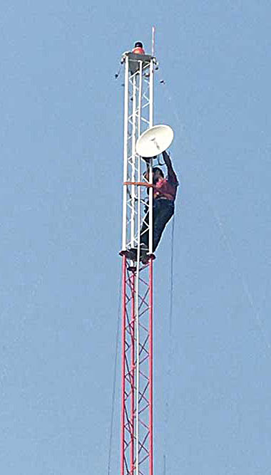 a person climbing on antenna