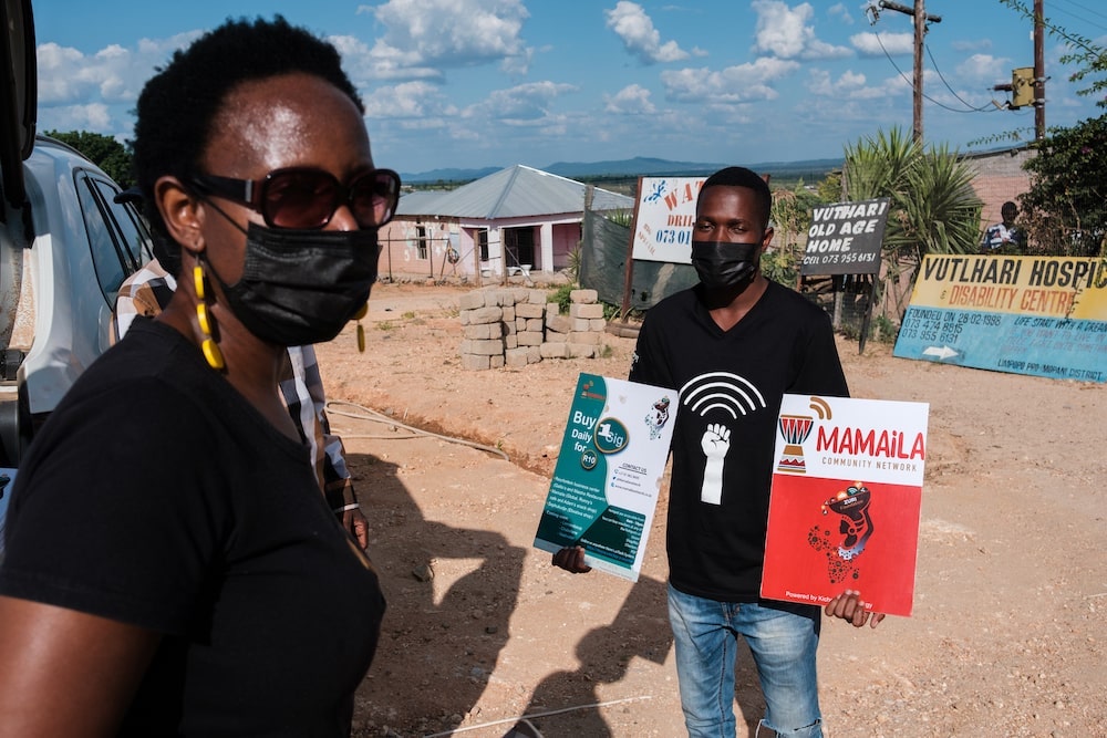 man with posters looking at a woman