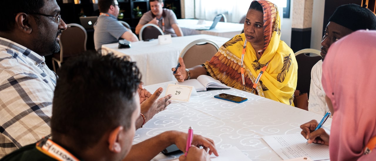 people sitting at a table discussing