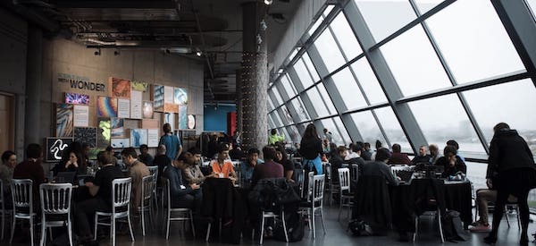 a group of people at tables in the office