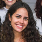 A headshot of Anna Martha Araujo smiling