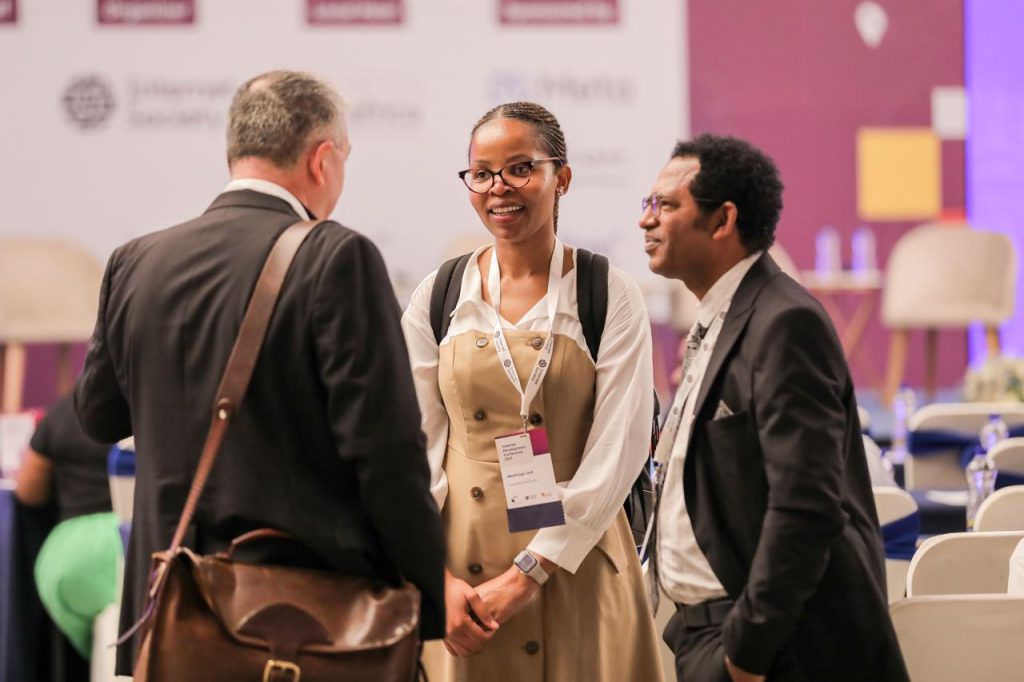 Three people standing in a circle having a conversation during the Internet Development Conference