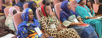 women sitting and listening to a conference