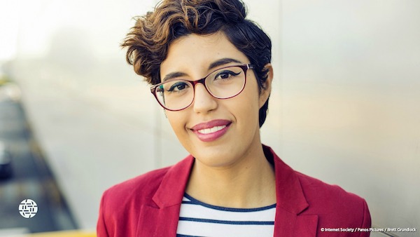 a young woman with short hair and glasses smiling 