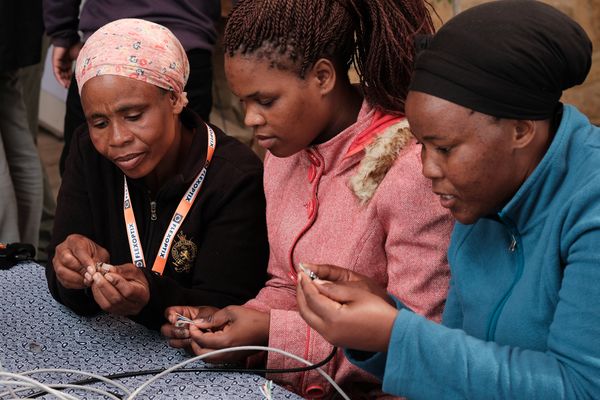 Three women crimping cables at the Africa CN summit