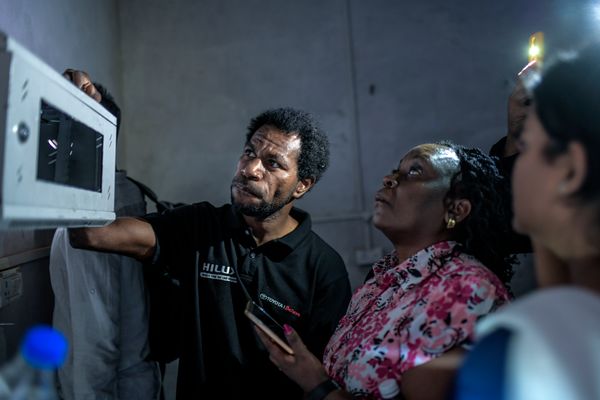 A group of people examining installations