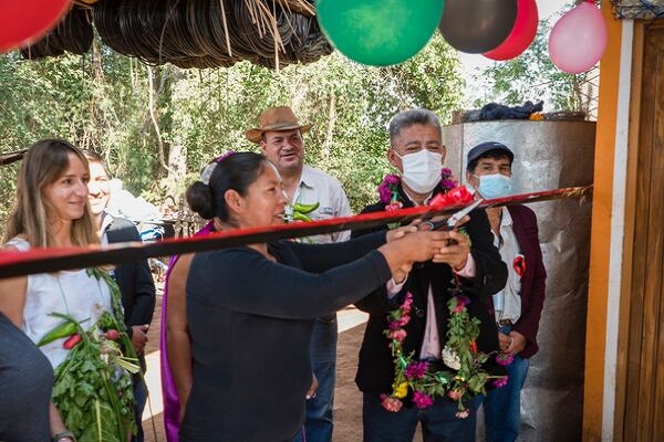 A group of people in Bolivia cutting the ribbon of a new CN