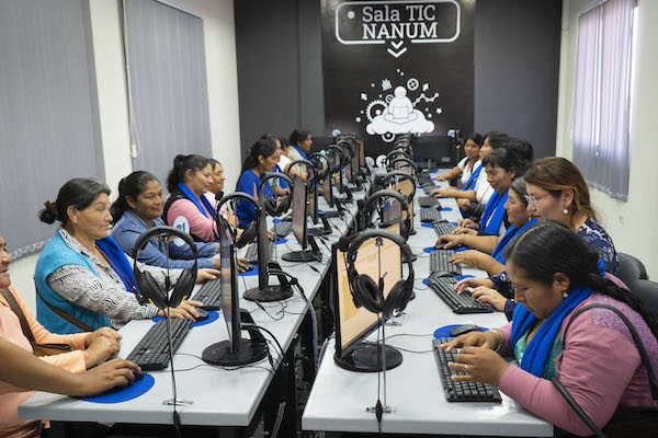 a group of women surfing the Internet in a huge conference room