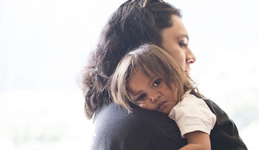 a person holding a baby on a shoulder