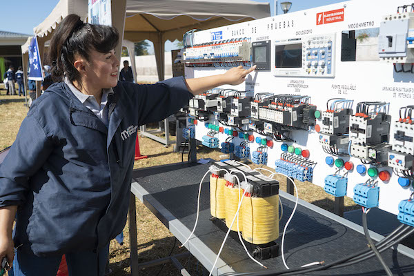 Woman operating an electrical panel in Bolivia