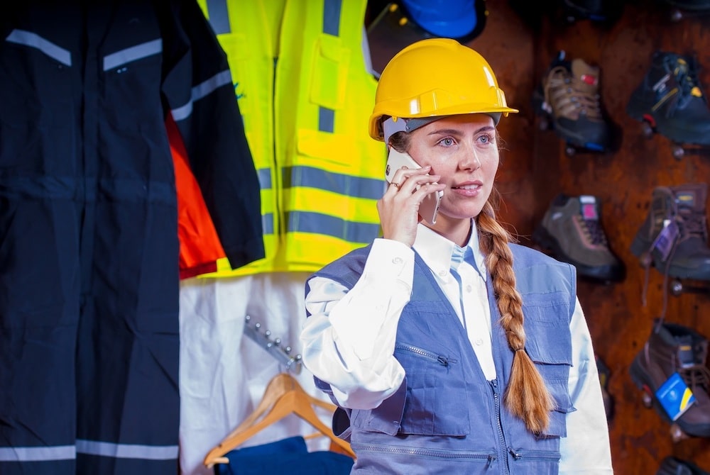 a woman wearing yellow helmet talking on mobile