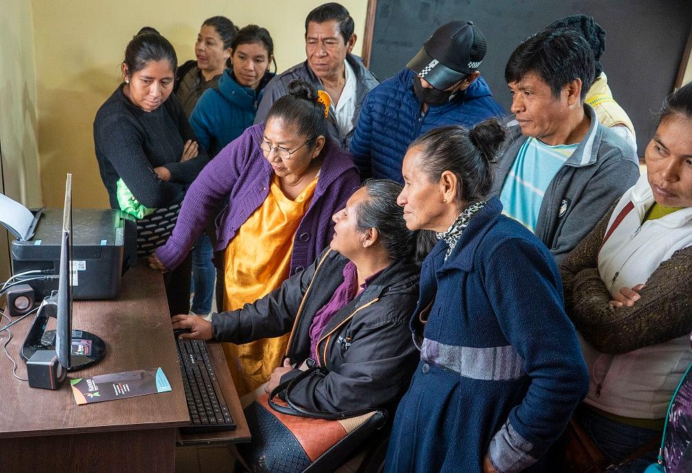 A group of people looking at a computer