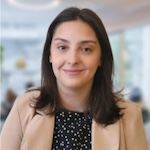 A woman wearing a suit jacket and a polka dot shirt