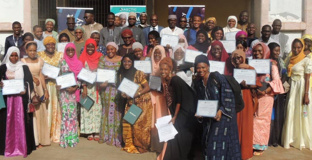 A group photo of women in West Mali holding their course certificates from the DDCN training course.