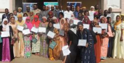 A group photo of women in West Mali holding their course certificates from the DDCN training course.