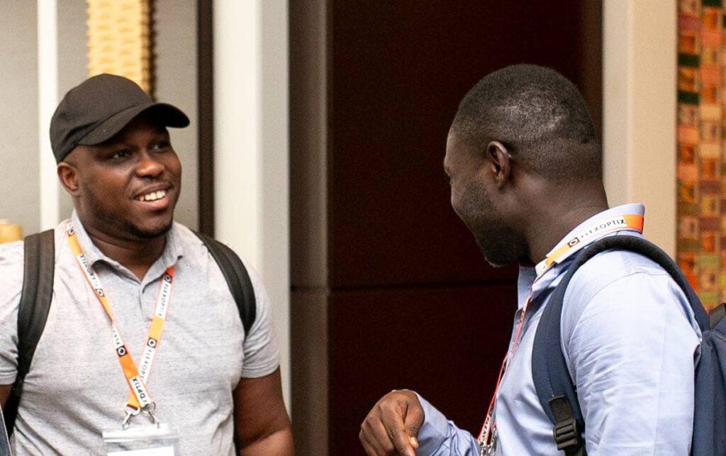 Two men speaking with each other at a peering event