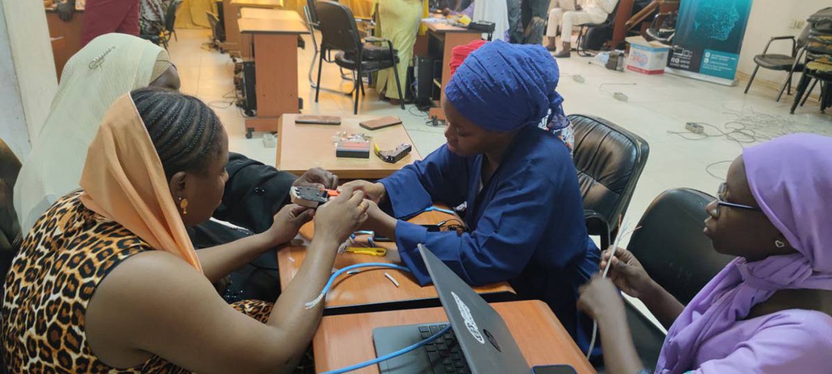 Women in the DDCN training course getting hands-on experience with hardware.