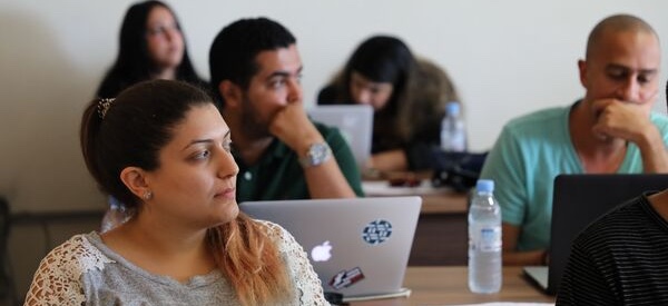 a group of people in front of their computers