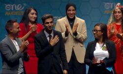 Photo of a group of people on stage, centered around Nojus Saad, previous Internet Society Youth Ambassador