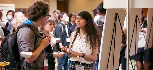 A diverse group of individuals gathered in a room, engaged in conversation