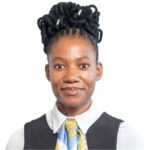 A woman with dreadlocks wearing a tie and vest.