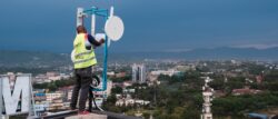 A man in Kenya stands on the roof of a building where a community network point of presence is located.