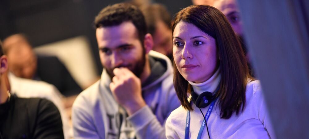 people at a conference listening