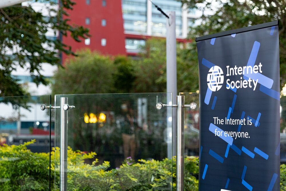 Internet Society's branded banner in a vibrant urban setting