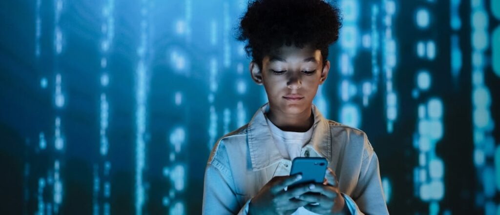 A youth engrossed in their phone.