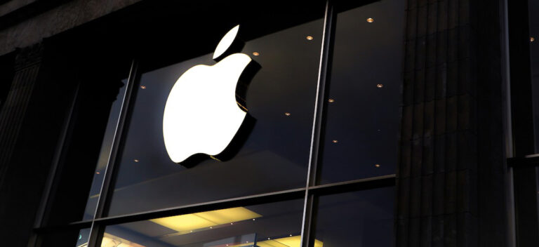 An outdoor sign of a white Apple logo