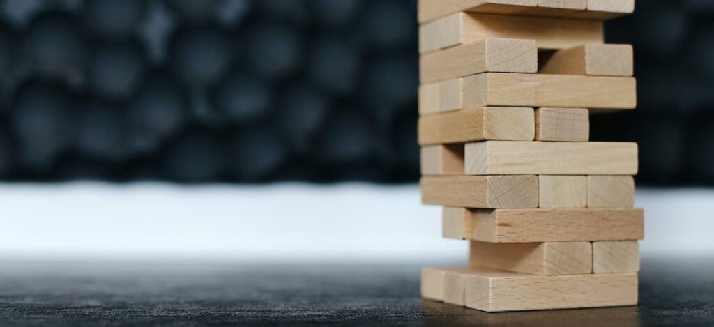 A tower of building blocks with critical pieces missing from bottom row.