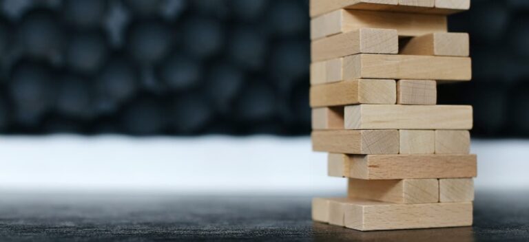 A tower of building blocks with critical pieces missing from bottom row.