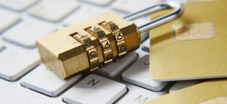 A gold lock on a white computer keyboard