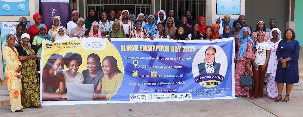 A large group of women stand outside and hold a Global Encryption Day banner