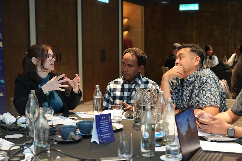 Several individuals seated at a table, sharing a lively discussion.