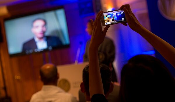 A person takes a photo with a cell phone