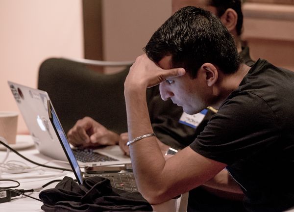 A man resting his head on his hand, appearing deep in thought