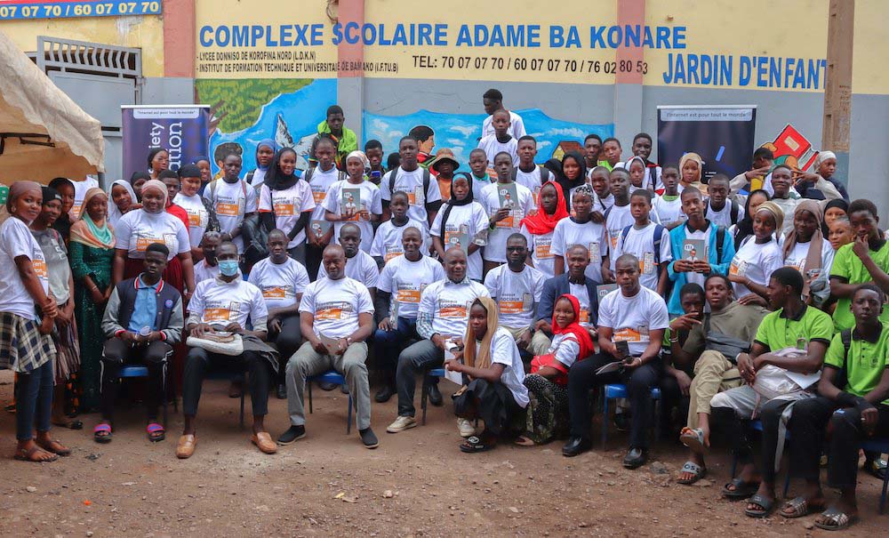 A large group of people pose together at a Mali Chapter event