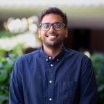 A man in a navy shirt smiling
