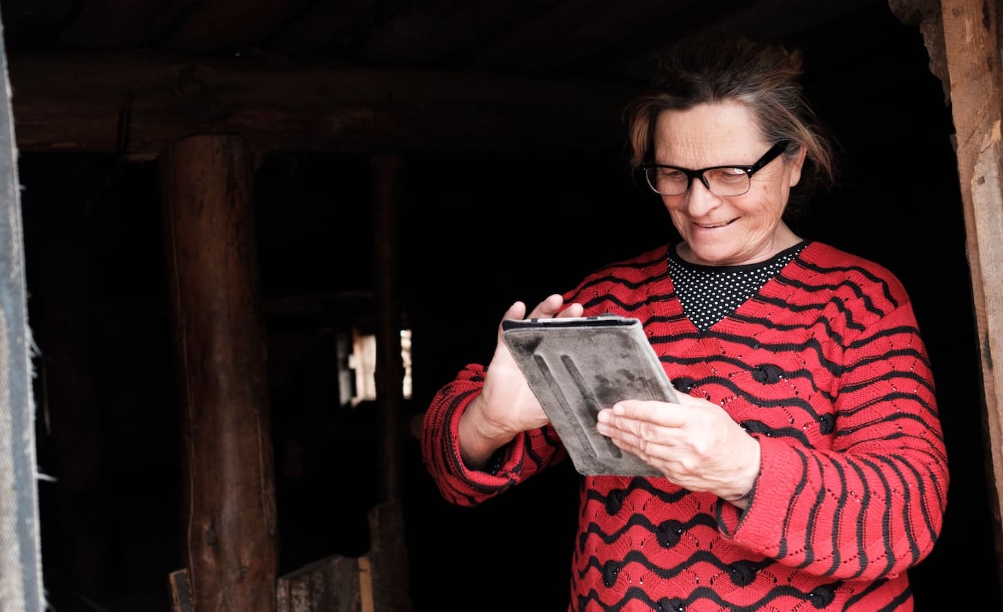 a woman looking at tablet smiling