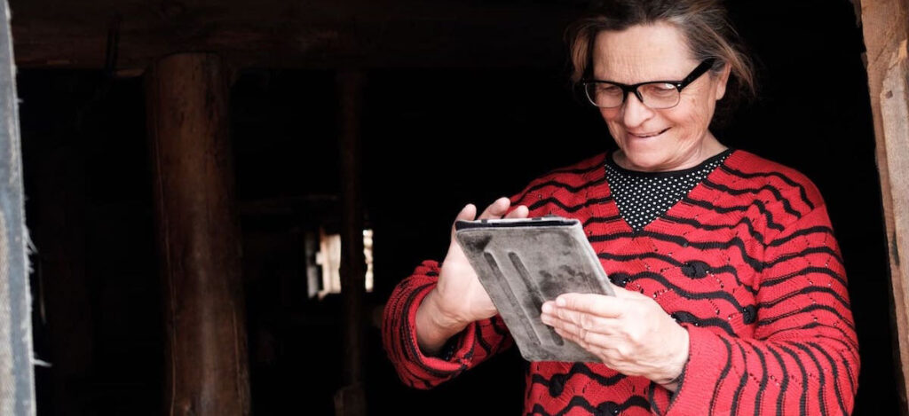 a woman looking at tablet smiling